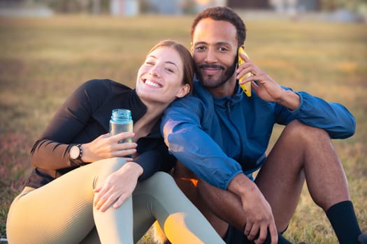 Happy, smiling, sporty friends, ready to exercise or train with a bottle of water in hand talking on a mobile phone looking at the camera. an active lifestyle, health and well-being.