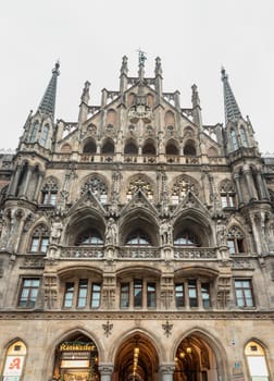 Munich, Germany - Dec 21, 2023 - Exterior architecture of famous New Town Hall (Neue Rathaus) on Marienplatz square in Munich. Gothic architectural style. Upper Bavaria, Space for text, Selective focus.