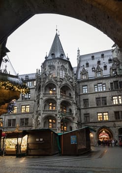 Munich, Germany - Dec 21, 2023 - The Festive illumination of A Christmas market held in courtyard of New Town Hall (Neue Rathaus) on Marienplatz square at Evening. Space for text, Selective focus.