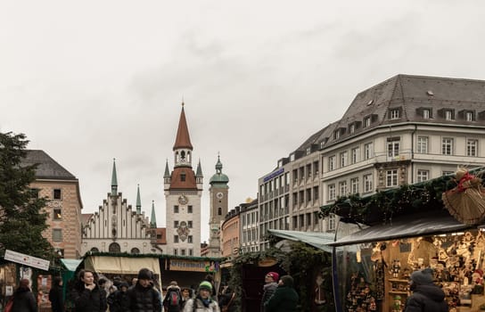 Munich, Germany - Dec 21, 2023 - The Festive of A Christmas market held on Marienplatz a central square in the city centre of Munich in front of Old Town Hall building (Altes Rathaus) now Toy Museum munich or Spielzeugmuseum. Copy space Selective focus.