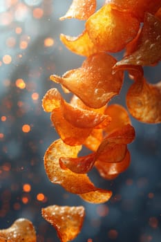 A close-up photo of a cascade of crispy potato chips falling through the air. The chips are golden brown and have a slight sheen, suggesting they are freshly fried. The background is out of focus and features warm, blurry bokeh lights, adding a sense of movement and excitement to the image.