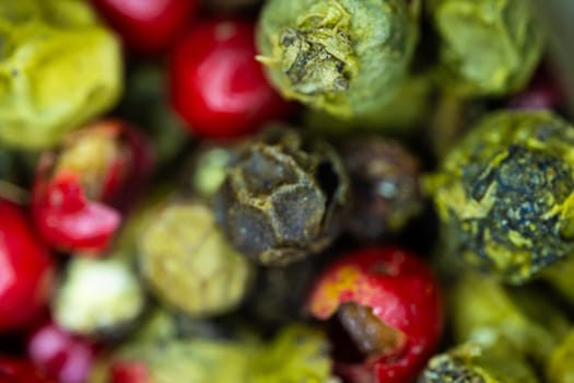 Close-up macro a vibrant mix of green, red, and black peppercorns