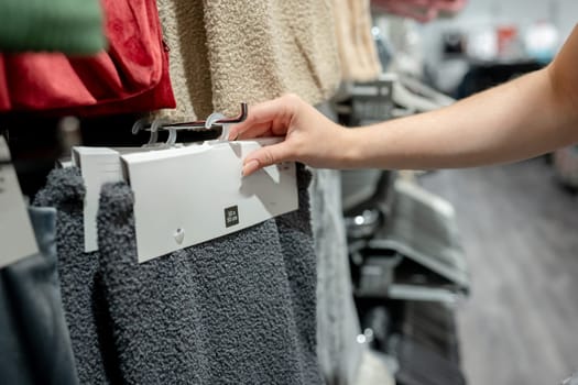 Young Girl In Store Chooses Pillowcase, Close-Up Of Hands