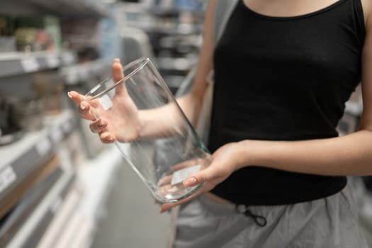 Young Girl In Store Selects Vase, Close-Up Of Hands