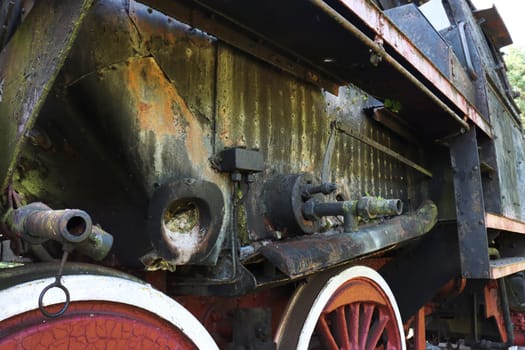 Chassis of an old steam locomotive. Chassis of an old steam locomotive...A fragment of the side and chassis of an abandoned retro locomotive.