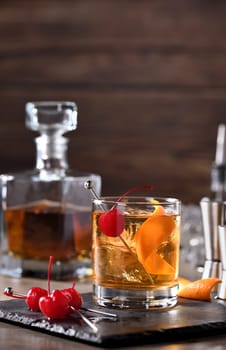 Cocktail Old Fashioned is an old-fashioned sophistication of whiskey and sweet syrup. Served with ice, orange zest and Maraschino cherry. 