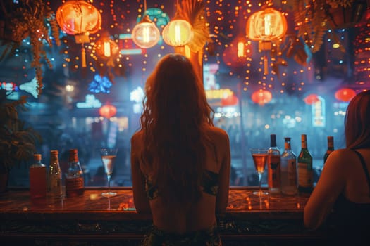 A woman with long curly hair sits at a bar counter with drinks and a view of a city street lit by colorful lanterns. The image is taken from behind the woman, and the focus is on the back of her head and shoulders as she leans forward with her hands resting on the counter.