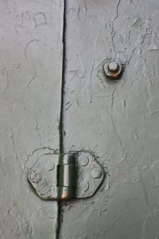 A close-up vertical photo of a fragment of a protective shield from an artillery gun.