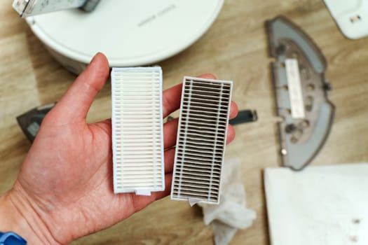 Robot vacuum filters lit home, showcasing the contrast between a pristine, clean filter and a used, dust-laden one