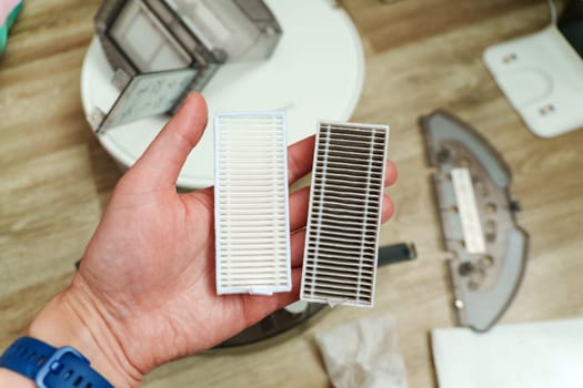 Robot vacuum filters lit home, showcasing the contrast between a pristine, clean filter and a used, dust-laden one