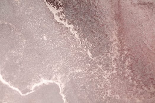 A close-up of a dusty rose sky at sunset with swirling clouds and glittering stars.