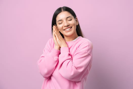 Dreamy vibes. Young woman in pink, eyes closed, smiling like she's in a sweet daydream. Perfect for capturing peaceful, blissed-out moments. Pure zen and happiness.