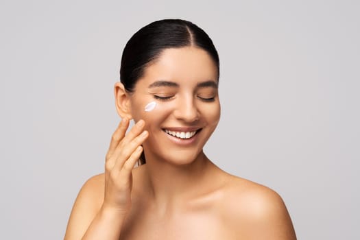 Skincare on fleek. Happy brunette with a glowing complexion and a winning smile. Ideal for beauty brands and self-care promotions.