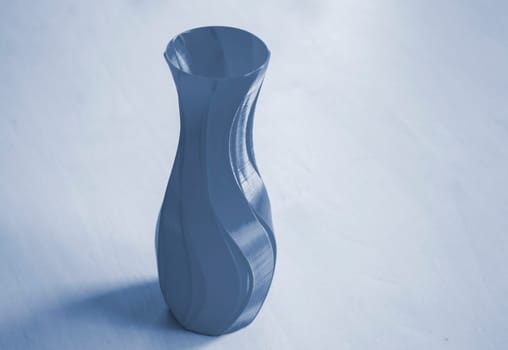 Object in the form of a vase printed on a 3D printer. Three-dimensional model printed on a 3D printer from molten plastic of red color. Concept 3D Printing. FDM 3D Printing technology