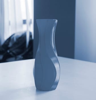 Object in the form of a vase printed on a 3D printer. Three-dimensional model printed on a 3D printer from molten plastic of red color. Concept 3D Printing. FDM 3D Printing technology