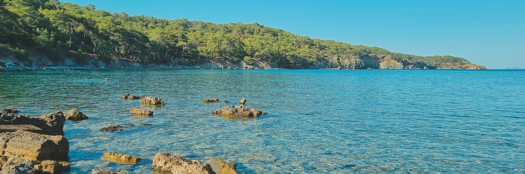 Banner of beautiful view of the rocky beach and blue clear sea water. summer holiday concept. summer card