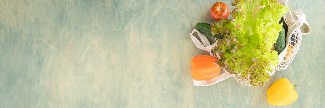 Banner of eco bag with vegetables. tomatoes, cucumbers, bell peppers and lettuce in a reusable bag. The concept of recycling, respect for nature. soft focus. top view
