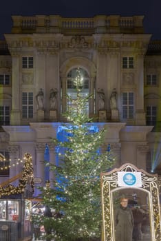 Berlin, Germany - Dec 19, 2023 - The Festive illumination of the palace facade at night. A Christmas market held in large courtyard of the restored Berlin Palace (Berliner Schloss) also known as Humboldt Forum Located on Schlossplatz. Copy space, Selective focus.