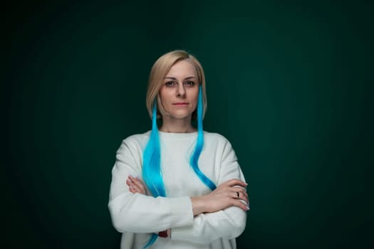 A woman with vibrant blue hair stands confidently with her arms crossed. She appears assertive and strong, exuding a sense of self-assuredness.