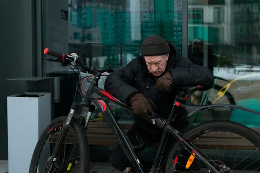 An elderly man went out for a bike ride in winter.