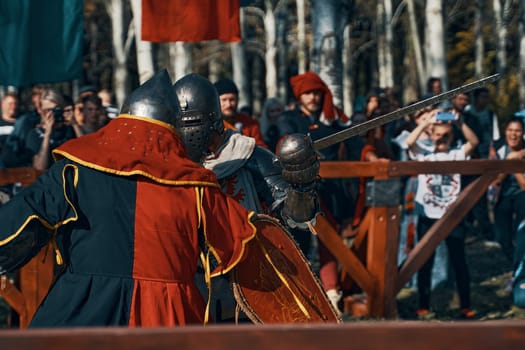 Festival of medieval culture. Imitation of jousting tournaments. Sword fighting. Arena with spectators. Bishkek, Kyrgyzstan - October 13, 2019