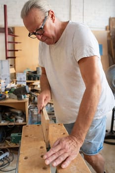 Carpenter working on wood craft. High quality photo