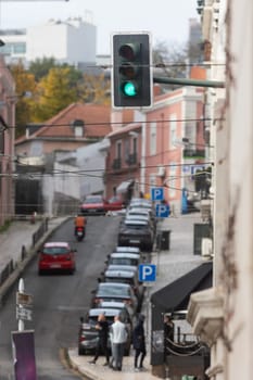 A green traffic light hanging over a city street