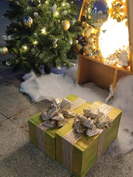 gift boxes with golden bows under the Christmas tree.