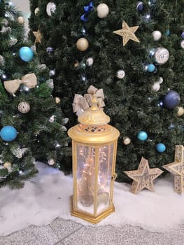 decorated Christmas tree and festive decorative lantern close-up.