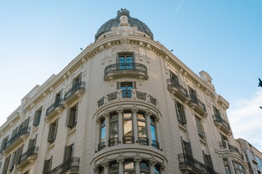 Historic building featuring a domed roof and ornate balconies. The elegant architectural design and detailed facade create a striking urban landmark.