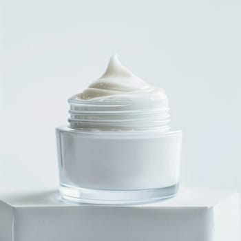 Face cream in a glass jar on a white and gold background. Skin care concept. Backdrop for beauty cosmetic products