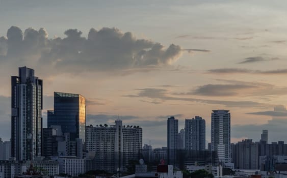 Bangkok, Thailand - 29 May 2024 - Beautiful Clouds in the Sky over Large Metropolitan City of Bangkok. View of Skyscrapers and Dramatic Sky before Sunset, Copy space, Selective focus.