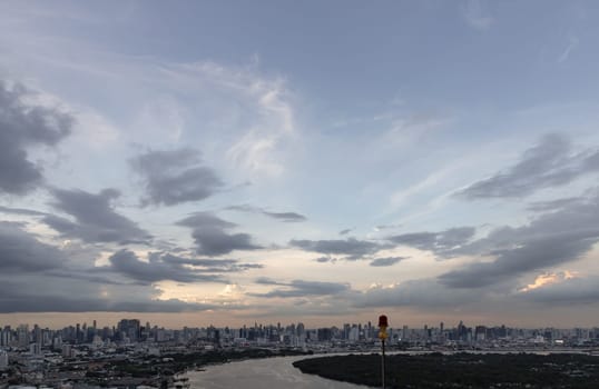 Bangkok, Thailand - 20 Jun, 2024 - Aerial view of skyscrapers and dramatic sky before sunset. Amazing clouds in the sky over large metropolitan city of bangkok along Chao Phraya riverside, Space for text, Selective focus.