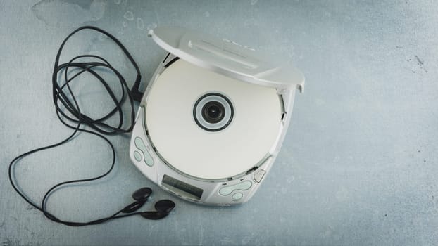 Close up of a vintage portable compact disc player on metal background.