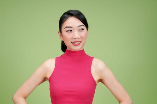 Close up portrait of young happy woman on green background