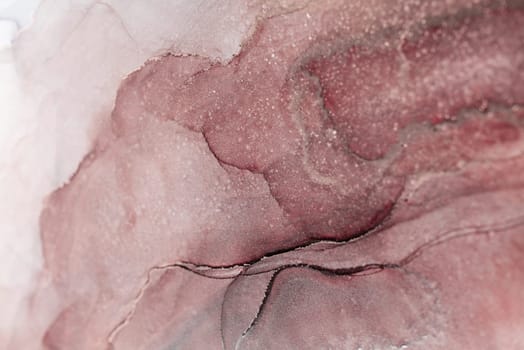 A close-up of an abstract painting featuring swirling, overlapping shades of pink and white ink.