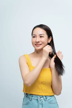 Woman Applying Hair Oil Treatment to Long Healthy Hair