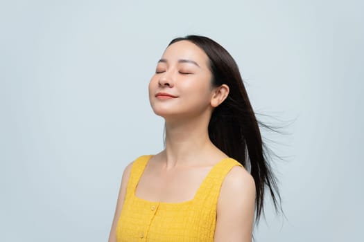 Smiling Woman in Yellow Dress Against Neutral Background