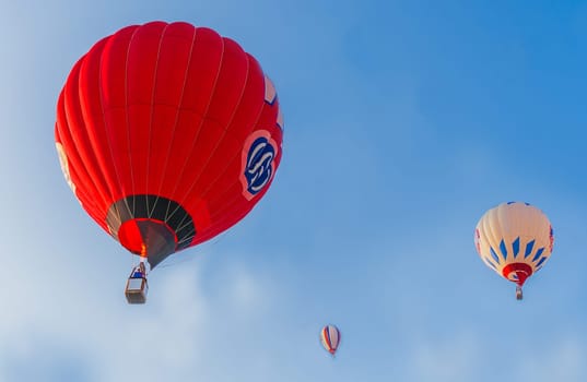 Balloons of red and white colors soar against a clear blue sky, Belarus, Minsk, Europe