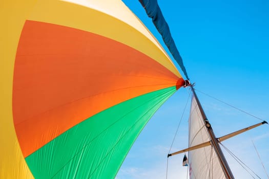 Colorful gennaker sail of a sailing yacht in the wind, sailing on the sea, calm sunny weather, gulf of Finland