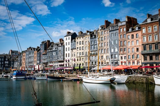 Honfleur, Normandy, France - 25-04-2024: People Sitting on the Terrace of the Restaurant. Port of Honfleur in the Calvados department in northwestern France