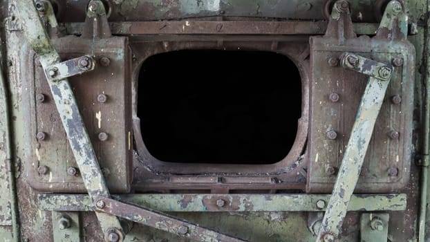 Broken locomotive firebox door. A close-up fragment of the open firebox in the engine of an abandoned retro locomotive.