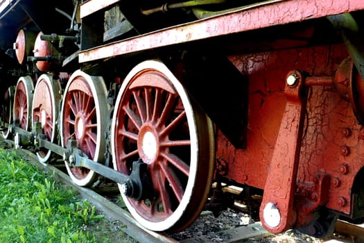 Parts, elements of mechanical parts, wheels and train equipment. Chassis of an old steam locomotive. Detail of one wheel of a vintage steam train locomotive