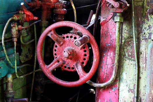 Steam engine controls. Fragment of the driver's cabin of a retro steam locomotive with steam engine controls, taps, valves, pipes, controls.