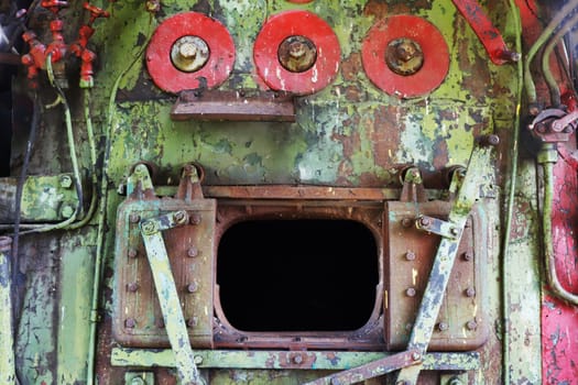 Fragment of the interior of the cabin, engine, firebox of an abandoned, non-working locomotive. Open oven.