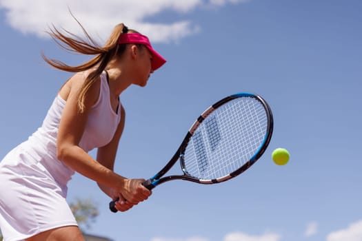 young woman playing tennis on the tennis court, olympic sport, outdoor activity concept
