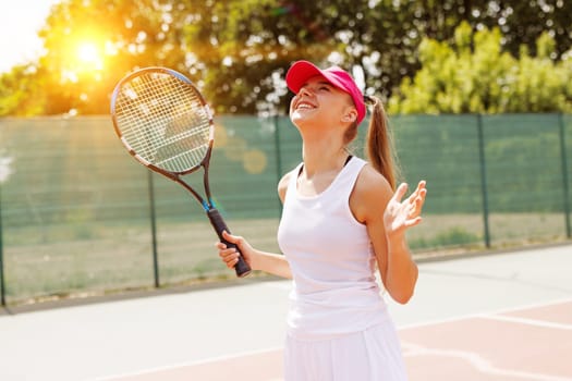 Excited young female tennis player celebrating victory on the card, tennis cup, victory in tennis, big tennis concept