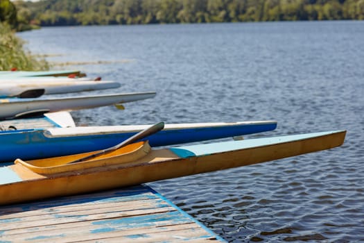athlete putting on water kayak, water sport, kayaking and canoeing, olympic games, rowing competition