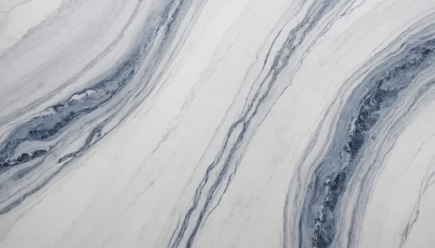 A close-up image of white and gray marble with natural veins that form a curved pattern. The surface is smooth and polished, with a gentle sheen.