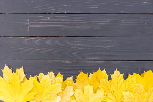 Autumn leaves frame on one down side wooden background top view Fall Border yellow and Orange Leaves vintage wood table Copy space. Mock up for your design. Display for product or text